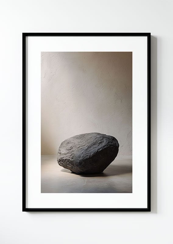 Affiche photographie contemporaine d'un rocher anthracite isolé sur fond de mur texturé, dans un cadre