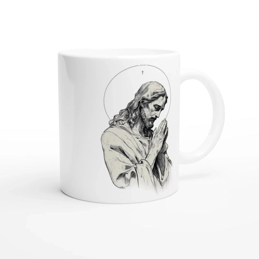 Mug en céramique blanche avec un dessin en noir et blanc représentant jésus les mains jointes