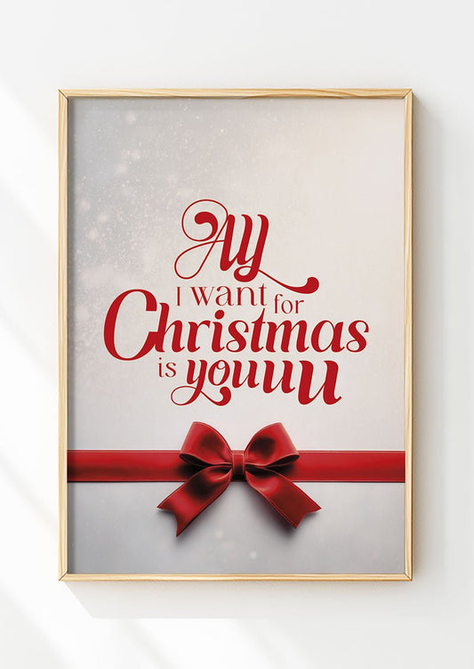 Affiche de noël typographie et nœud rouge "all i want" encadrée dans un cadre en bois