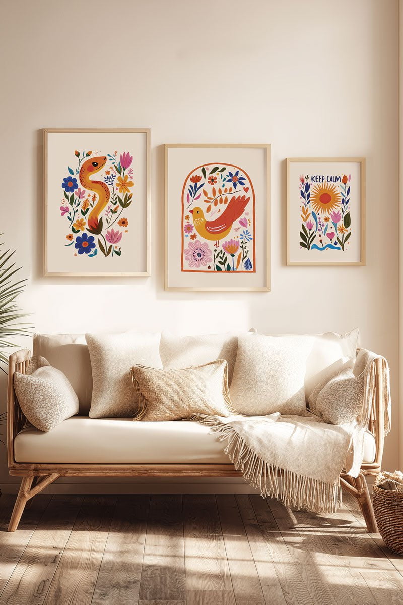 Mise en situation de trois affiches folk art différentes au dessus d'un canapé beige