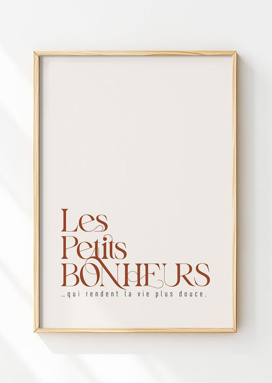 Affiche automne "les petits bonheurs" en typographie marron dans un cadre en bois