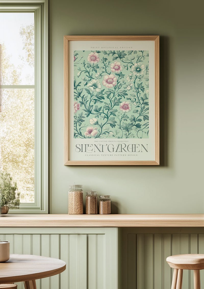 Affiche murale Williams Morris de fleurs roses sur un mur vert-amande dans une cuisine.